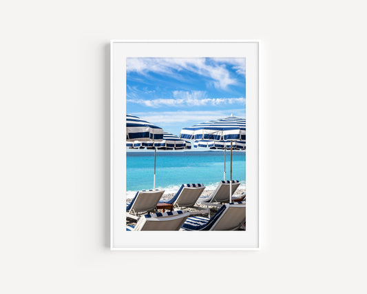 Striped blue and white umbrellas at Ruhl Plage Beach Club in Nice, France.