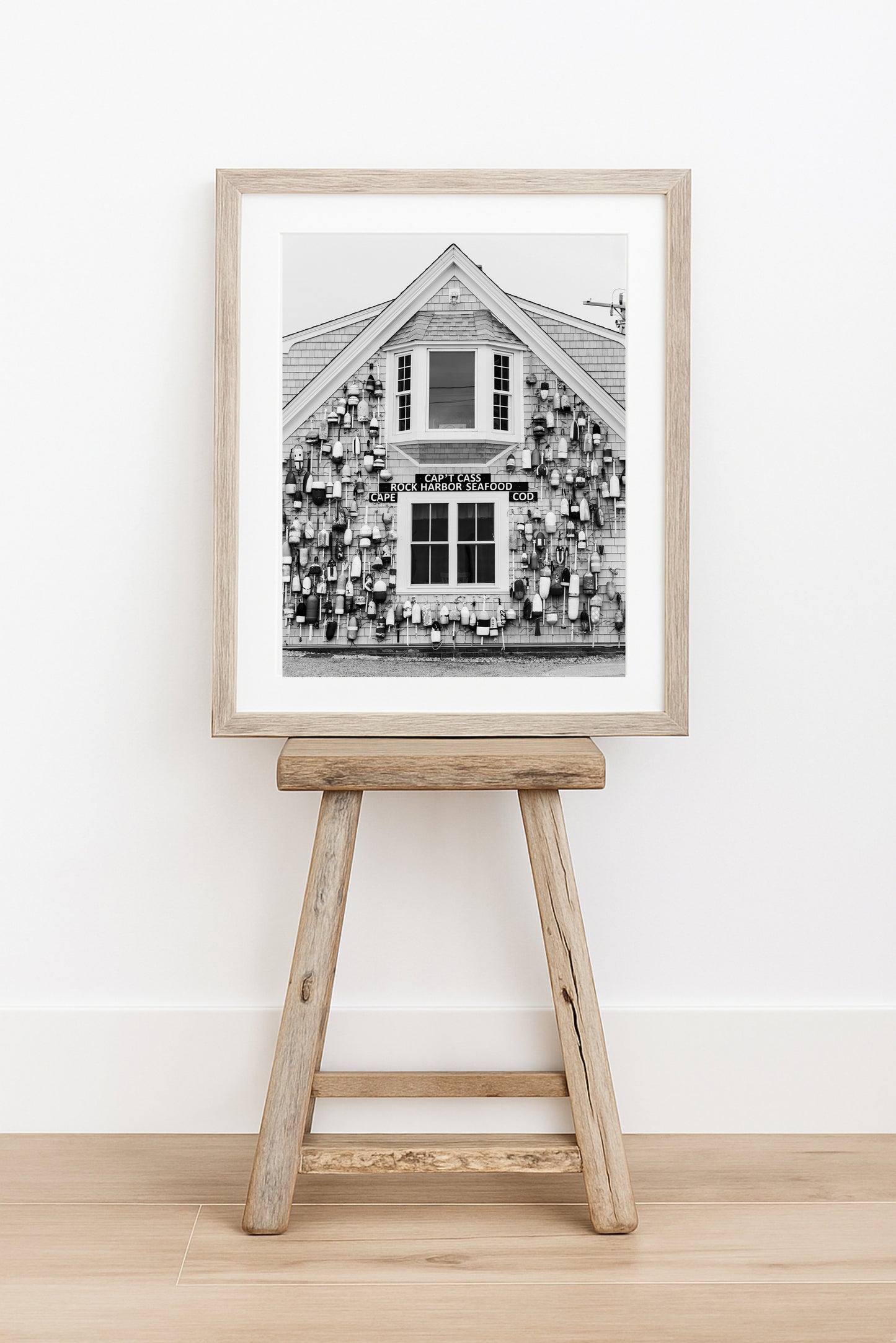 Black and white coastal wall art of Cape Cod seafood shack covered in lobster buoys — perfect for nautical and rustic New England decor.
