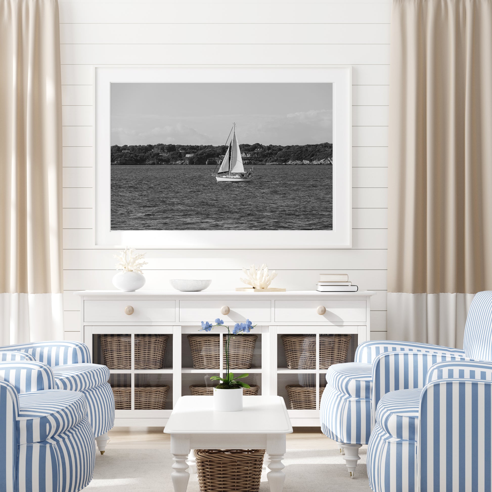 Horizontal black and white sailboat photo taken in Newport, Rhode Island, featuring a single sailboat on open water with a calm shoreline in the background. Ideal for coastal wall decor and lake house art.