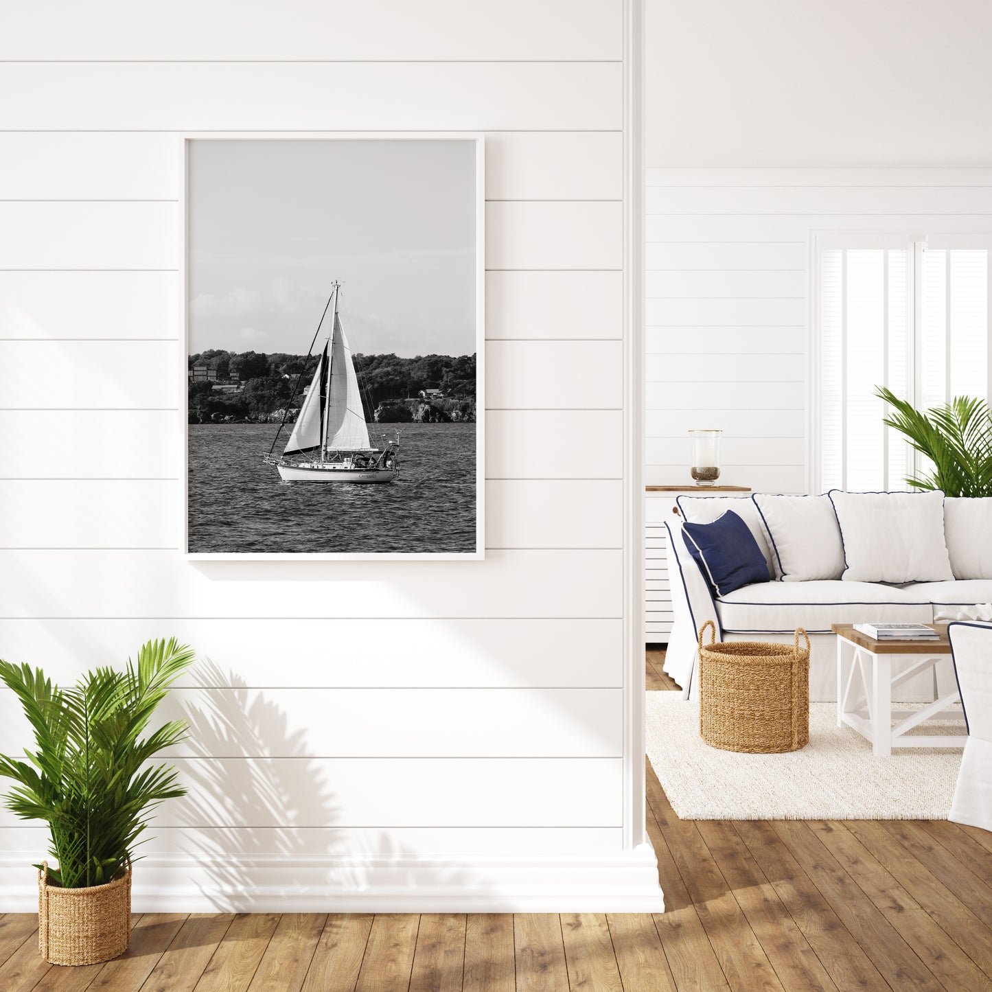 Black and white photo of a sailboat sailing in Newport, Rhode Island, with calm ocean water and soft horizon in the background. Coastal nautical wall art.