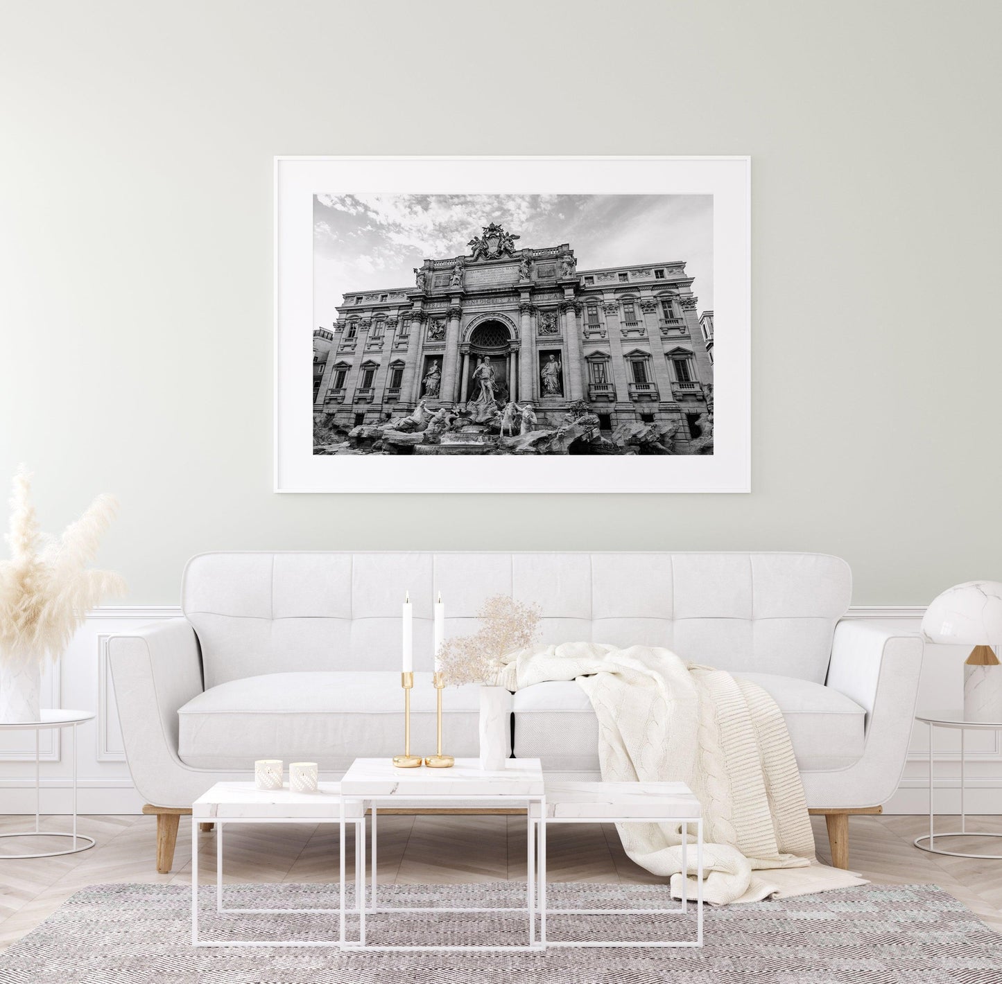 Black and white aerial photograph of the Trevi Fountain in Rome, Italy, surrounded by rooftops and city streets.