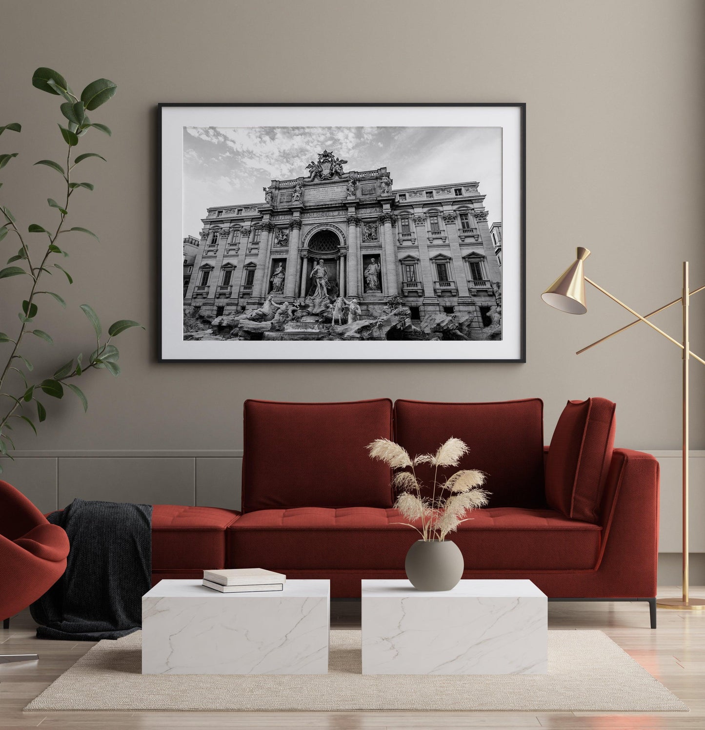 Black and white aerial photograph of the Trevi Fountain in Rome, Italy, surrounded by rooftops and city streets.