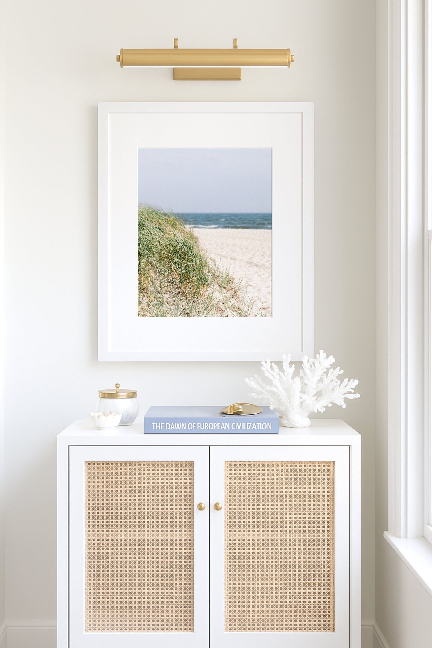 Neutral-toned beach photography of sand dunes and beach grass under a pale sky, evoking a coastal New England feel with a Nantucket aesthetic
