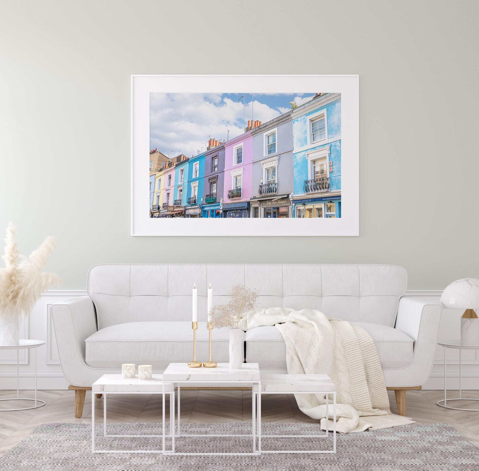 Colorful pastel buildings on Portobello Road in Notting Hill, London under a partly cloudy sky