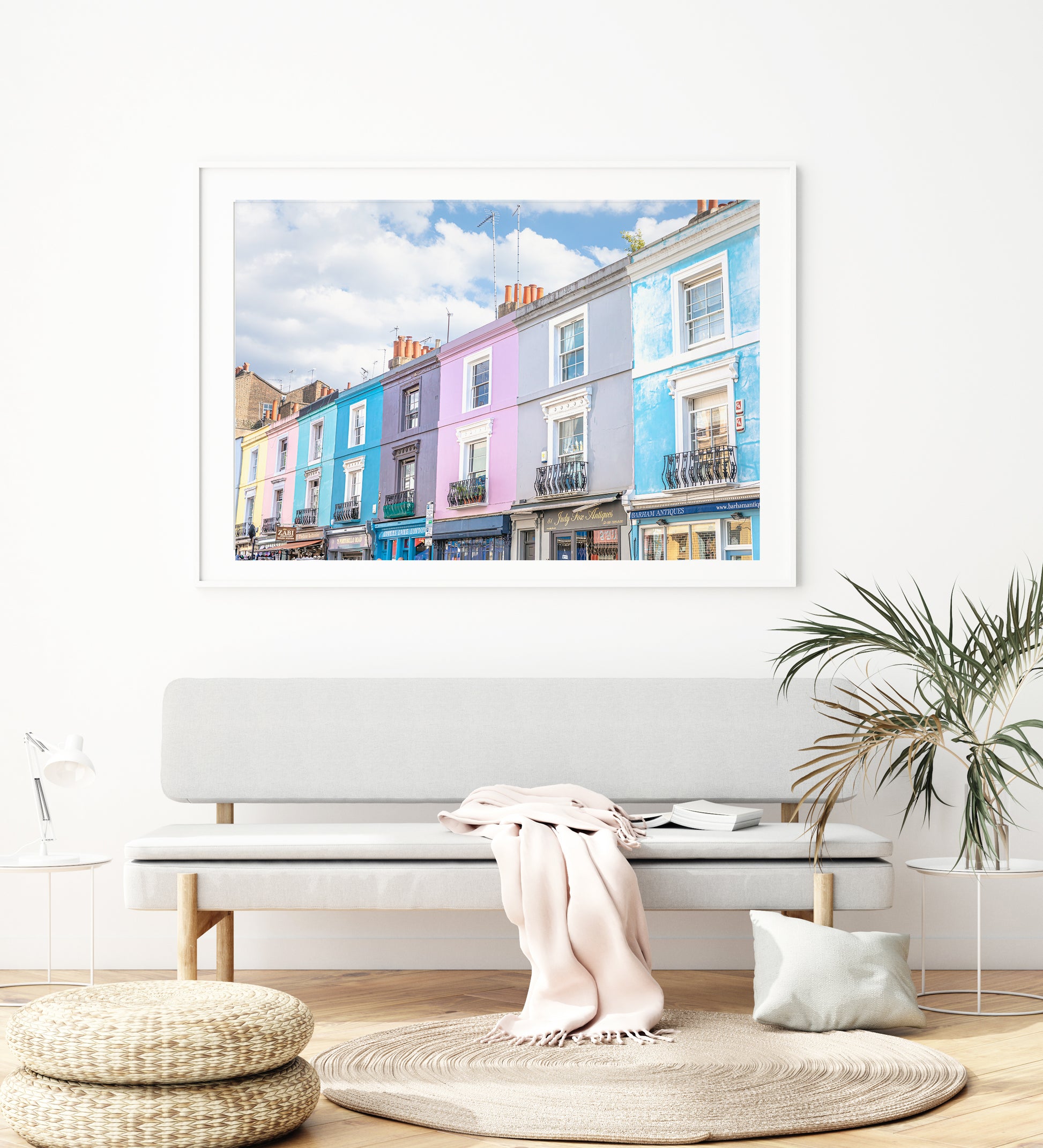 Colorful pastel buildings on Portobello Road in Notting Hill, London under a partly cloudy sky