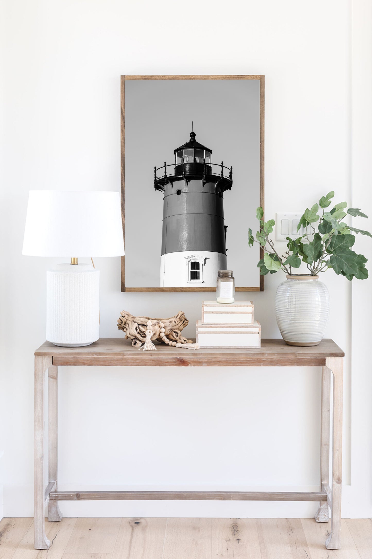 Black and white photograph of Nauset Lighthouse in Eastham, Massachusetts, featuring the iconic tower set against a pale sky. A minimalist coastal print ideal for Cape Cod–inspired decor and nautical wall art.