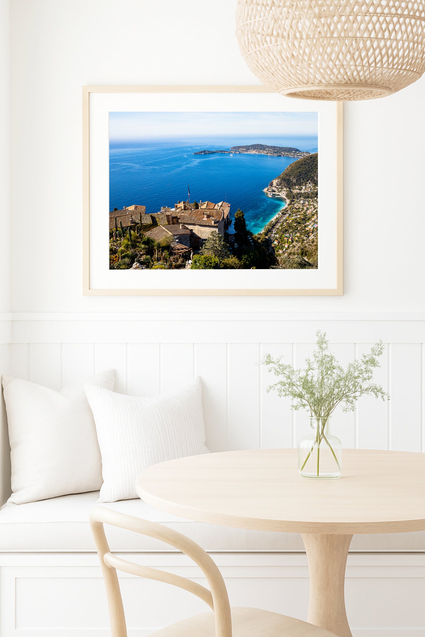 Village of Èze, France print featuring rooftops and the Mediterranean Sea styled in a neutral kitchen setting
