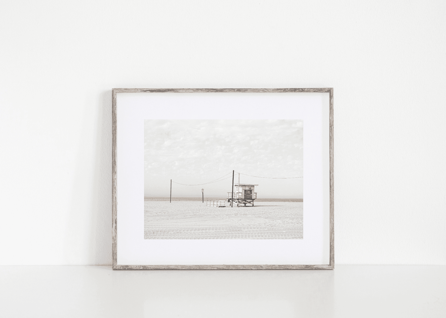 Framed black and white vintage beach photo with a lifeguard stand and ocean in the background. Beach print.