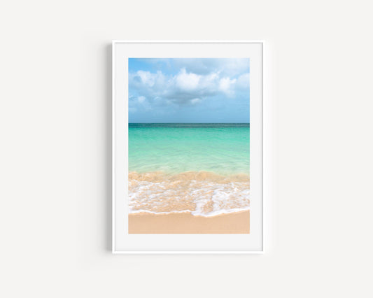Vibrant ocean waves at Eagle Beach, Aruba with clear turquoise water and soft golden sand under a bright sky — colorful beach photography perfect for tropical and modern coastal decor.