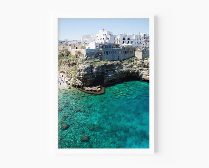 Aerial beach photo of Polignano a Mare with cliffs, turquoise sea, and Italian architecture in Puglia, Italy