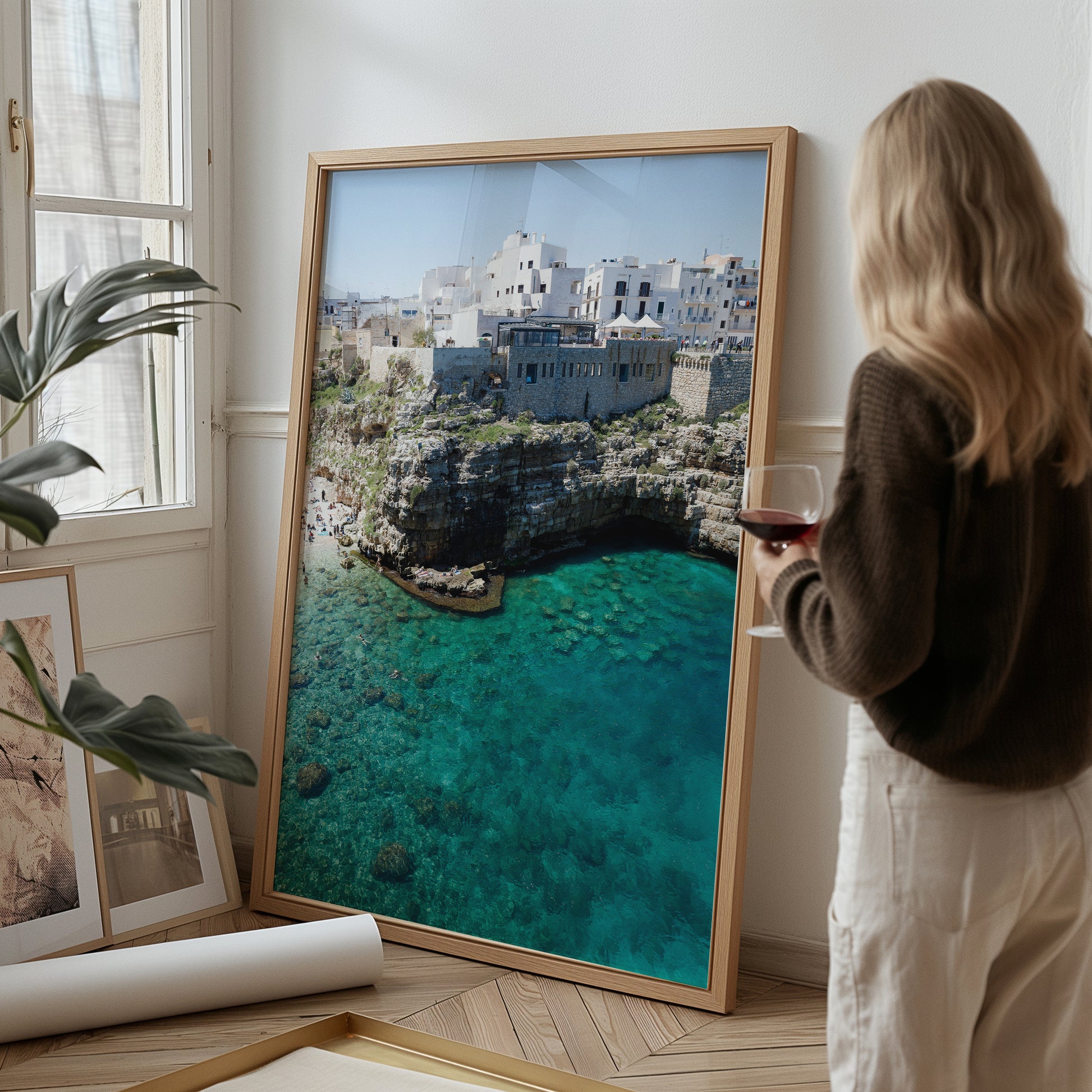 Aerial beach photo of Polignano a Mare with cliffs, turquoise sea, and Italian architecture in Puglia, Italy