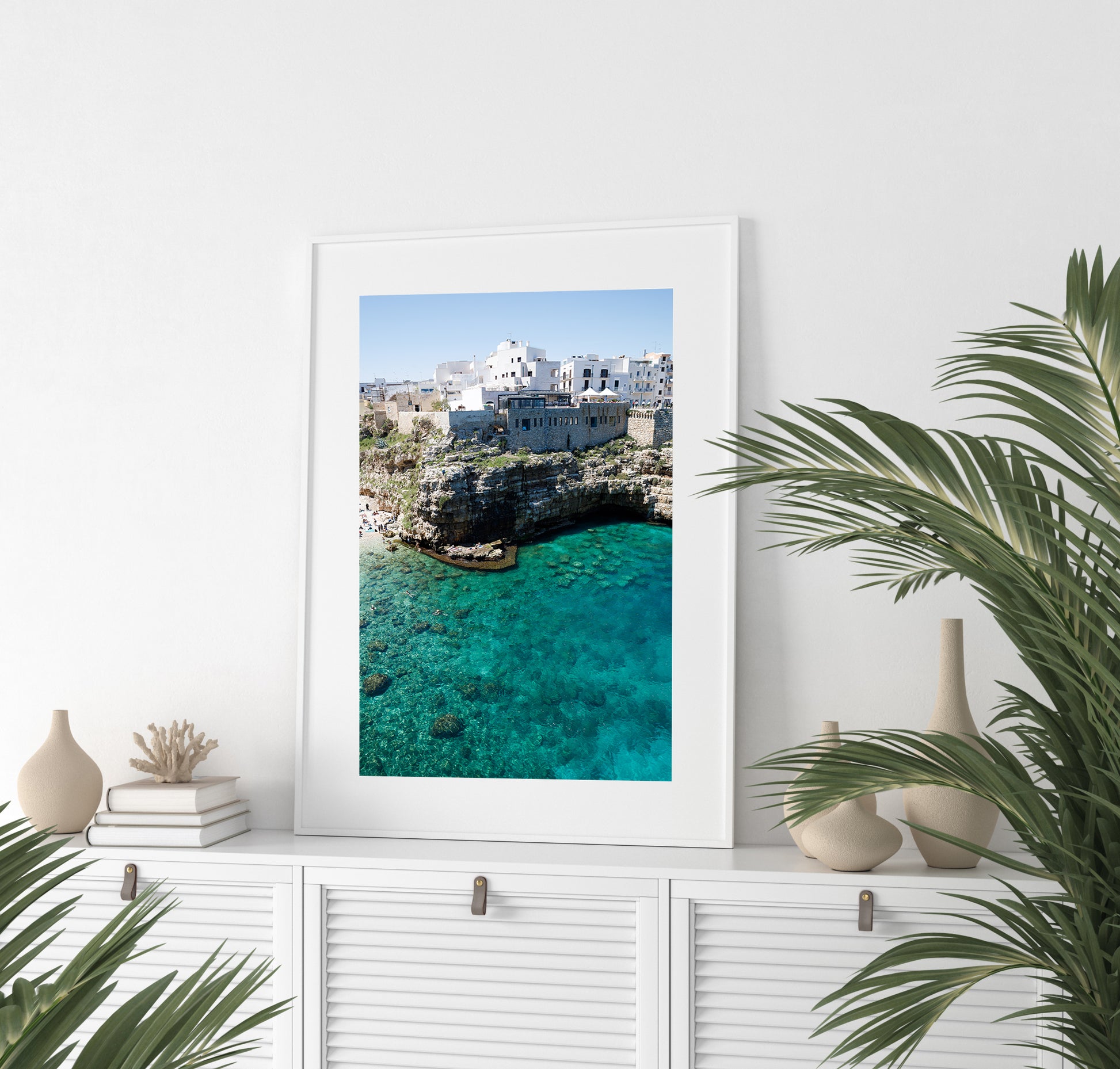 Aerial beach photo of Polignano a Mare with cliffs, turquoise sea, and Italian architecture in Puglia, Italy