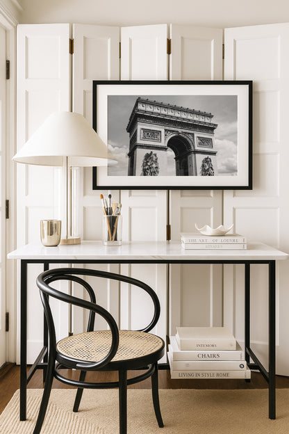 Black and white photograph of the Arc de Triomphe in Paris, taken from the Champs Elysées with strong architectural lines and soft contrast.