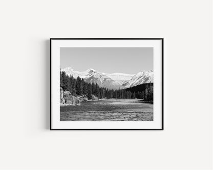 Black and white nature photography print of the Bow River in Banff National Park, with pine trees and Canadian Rockies in Alberta Canada.