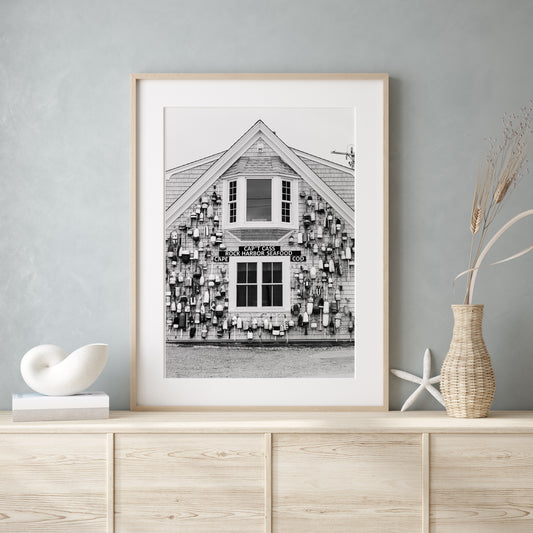 Black and white coastal wall art of Cape Cod seafood shack covered in lobster buoys — perfect for nautical and rustic New England decor.