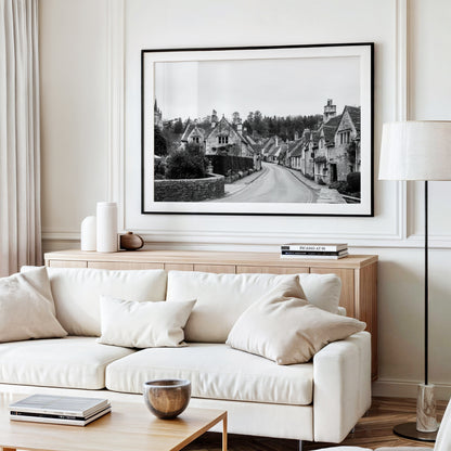 Black and white photography print of Castle Combe village in the Cotswolds England with historic stone cottages and winding road