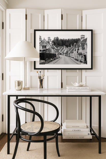 Black and white photography print of Castle Combe village in the Cotswolds England with historic stone cottages and winding road