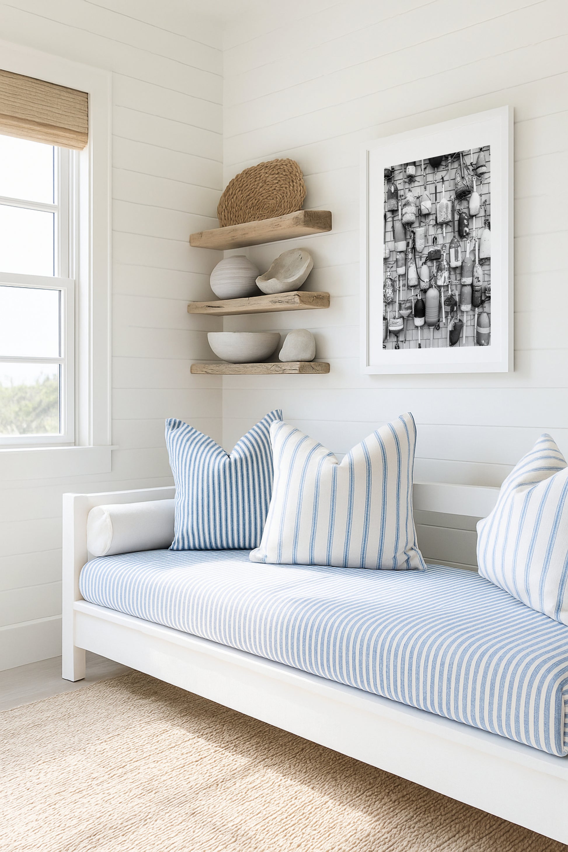 Black and white photograph of weathered fishing buoys hanging on a wood wall, captured in Cape Cod. Nautical wall art with a rustic coastal feel.