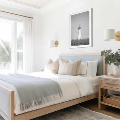 Black and white fine art photograph of Great Point Lighthouse and keeper's house on Nantucket Island — weathered white tower above dark dune grass against a flat grey sky, remote coastal wall art