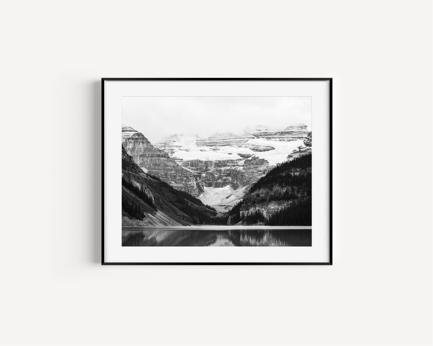 Black and white photo of Lake Louise in Banff National Park, Alberta Canada with mountains reflected in the Canadian Rockies