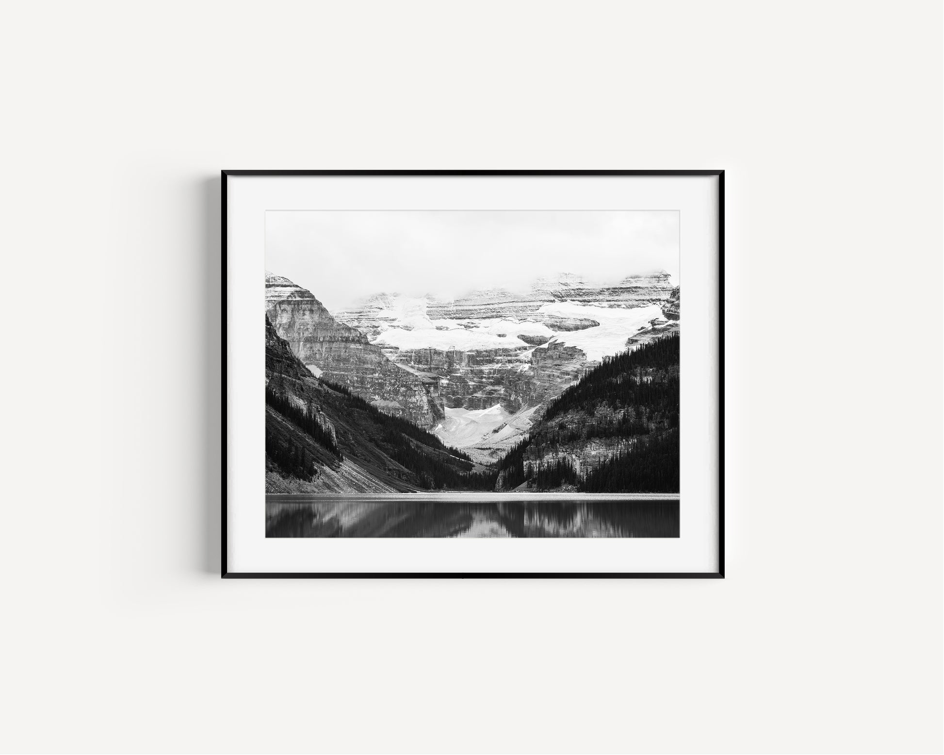 Black and white photo of Lake Louise in Banff National Park, Alberta Canada with mountains reflected in the Canadian Rockies