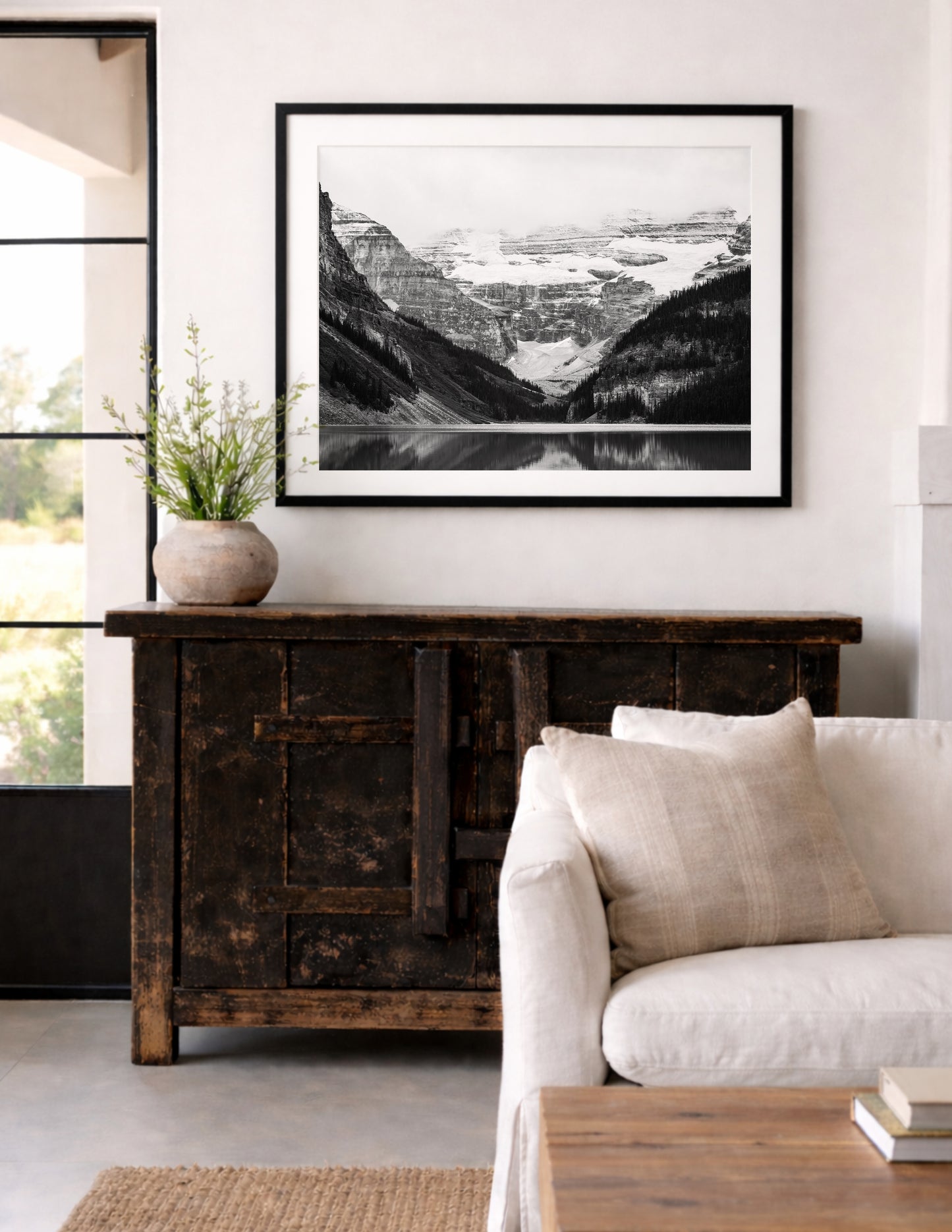 Black and white photo of Lake Louise in Banff National Park, Alberta Canada with mountains reflected in the Canadian Rockies