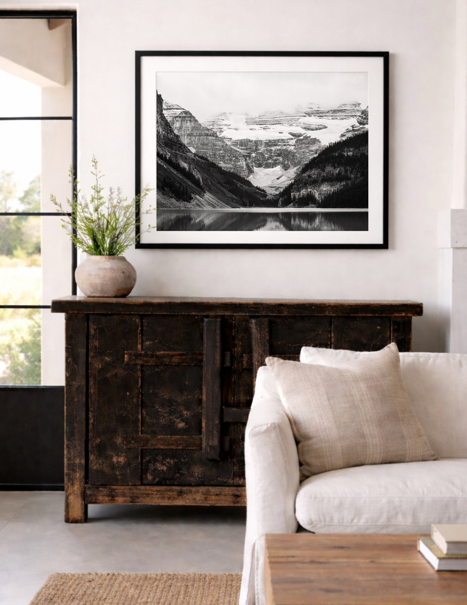 Black and white photo of Lake Louise in Banff National Park, Alberta Canada with mountains reflected in the Canadian Rockies