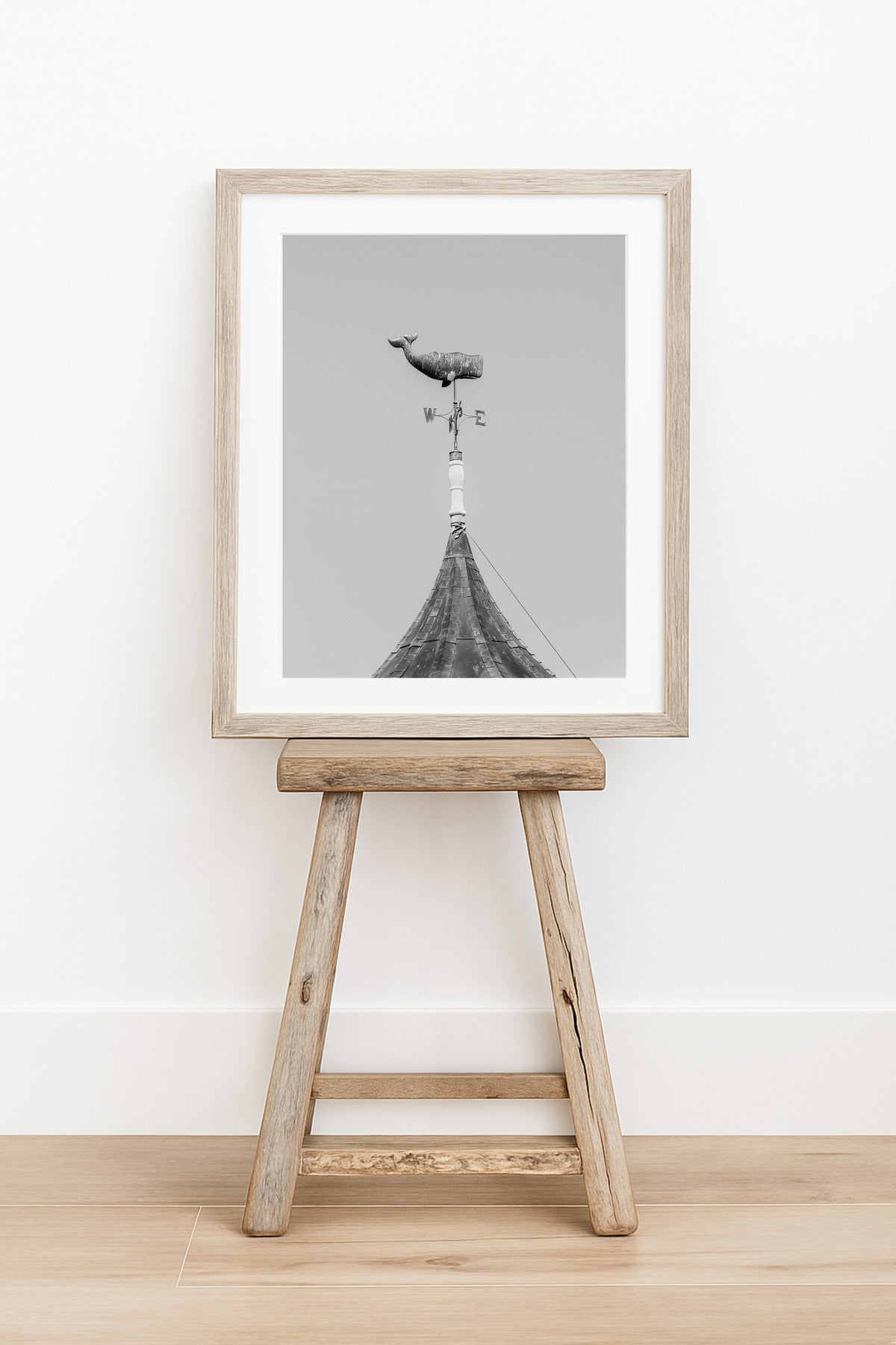 Whale weathervane black and white Martha’s Vineyard photography print, weathered nautical weathervane on rooftop against grey sky, New England coastal wall art for beach house, cottage, or living room