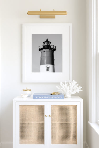 Black and white photograph of Nauset Lighthouse in Eastham, Massachusetts, featuring the iconic tower set against a pale sky. A minimalist coastal print ideal for Cape Cod–inspired decor and nautical wall art.