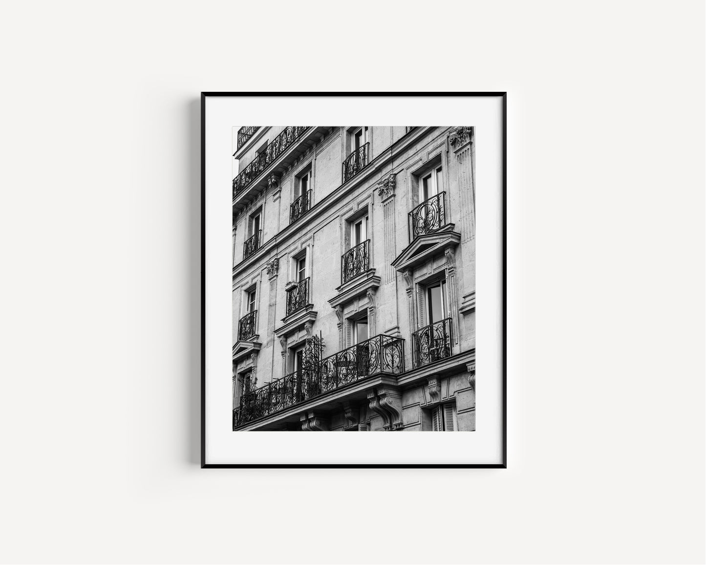 Black and white photo of French balcony with ornate railings in Paris