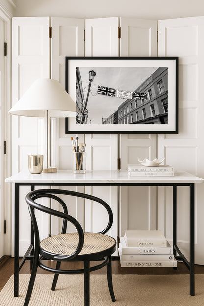 Black and white photograph of Portobello Road Market in Notting Hill, London featuring historic shops and a quiet city street scene.