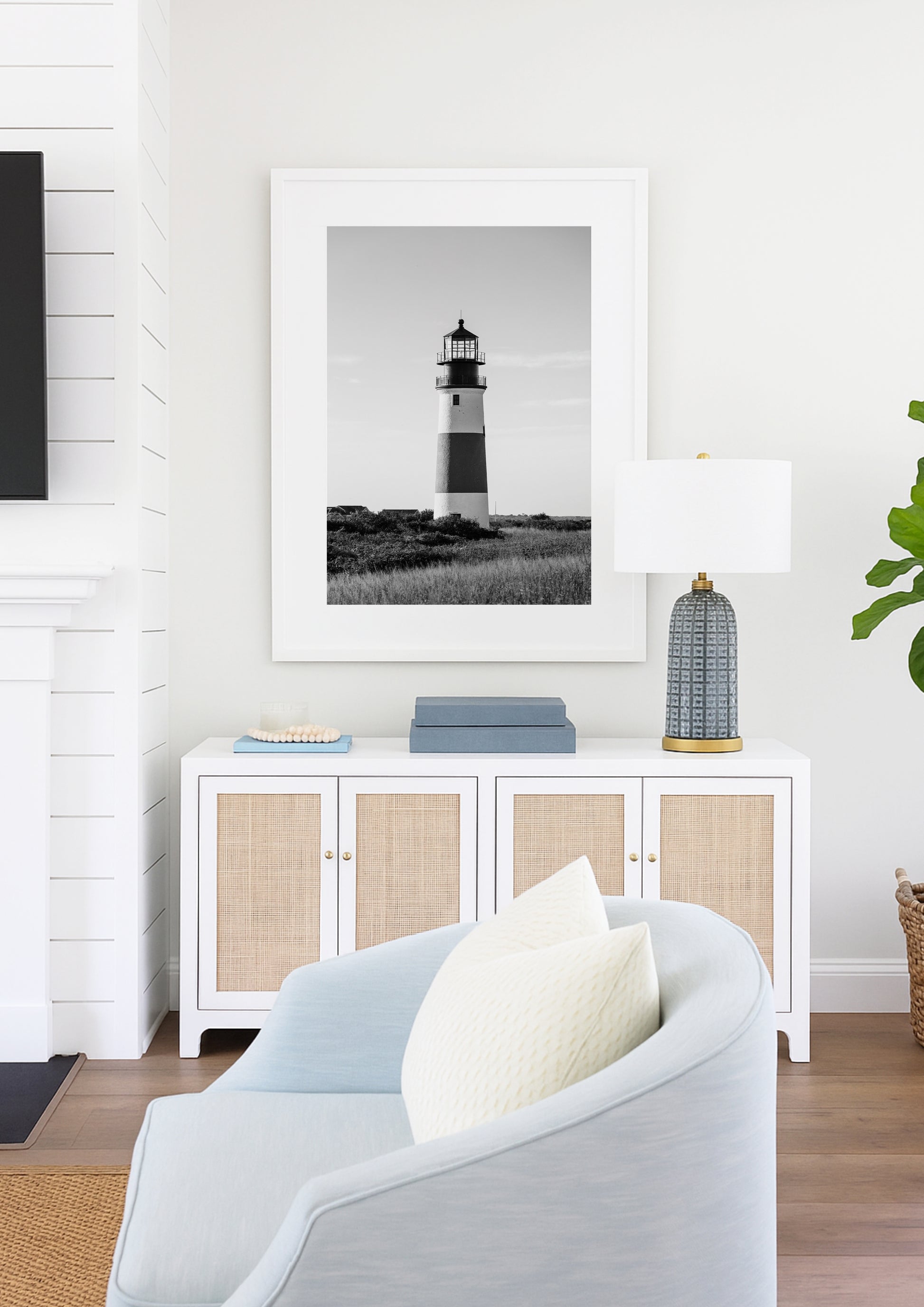 Black and white fine art photograph of Sankaty Head Lighthouse on Nantucket Island — banded tower rising above wild moor grass against an open sky in Siasconset