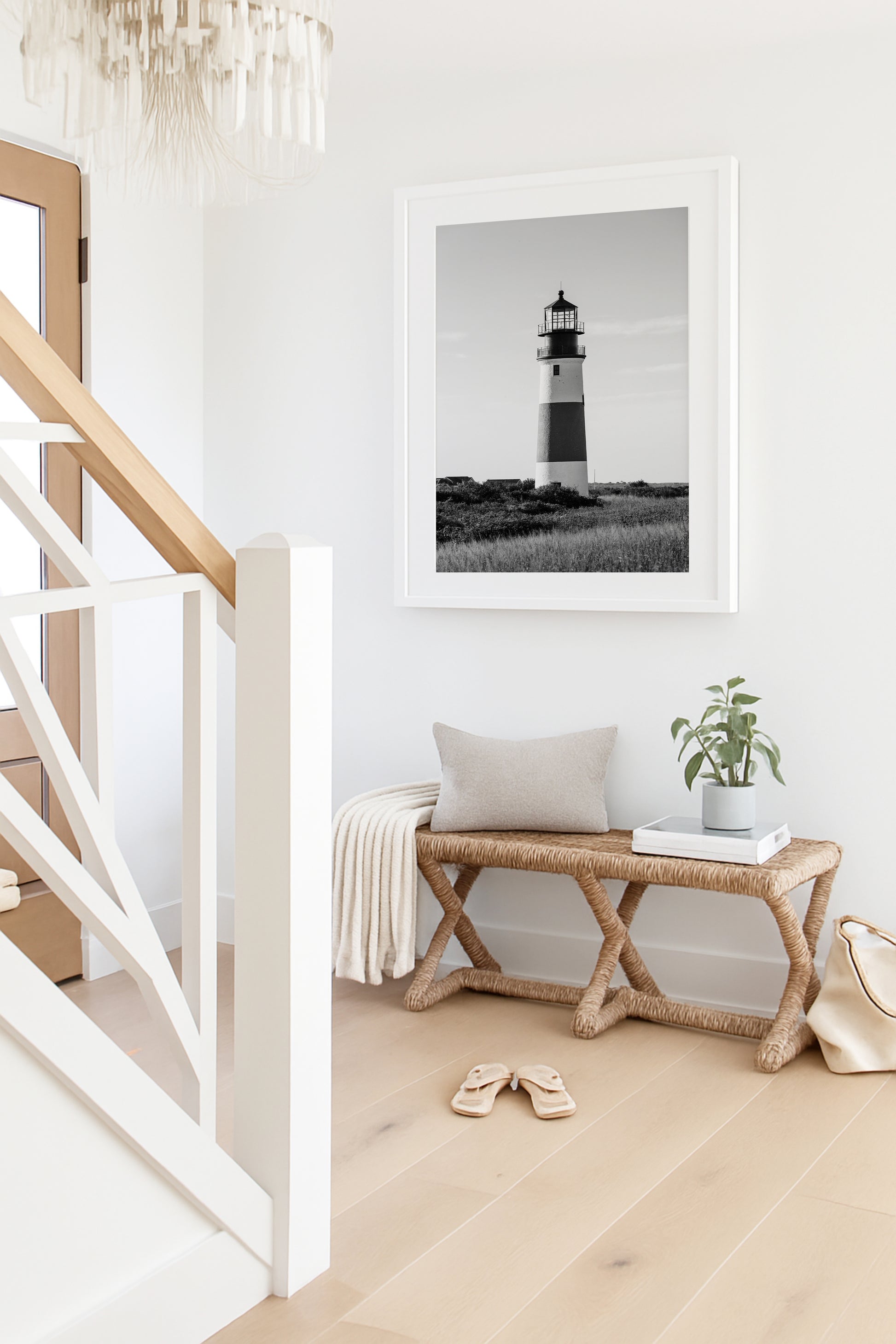 Black and white fine art photograph of Sankaty Head Lighthouse on Nantucket Island — banded tower rising above wild moor grass against an open sky in Siasconset