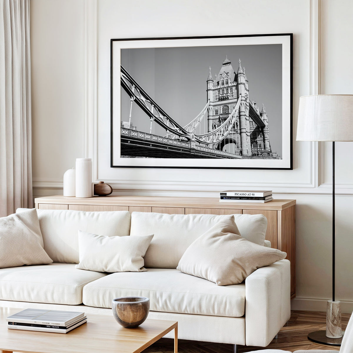 Black and white photograph of Tower Bridge in London, highlighting the bridge's historic architecture and suspension towers.