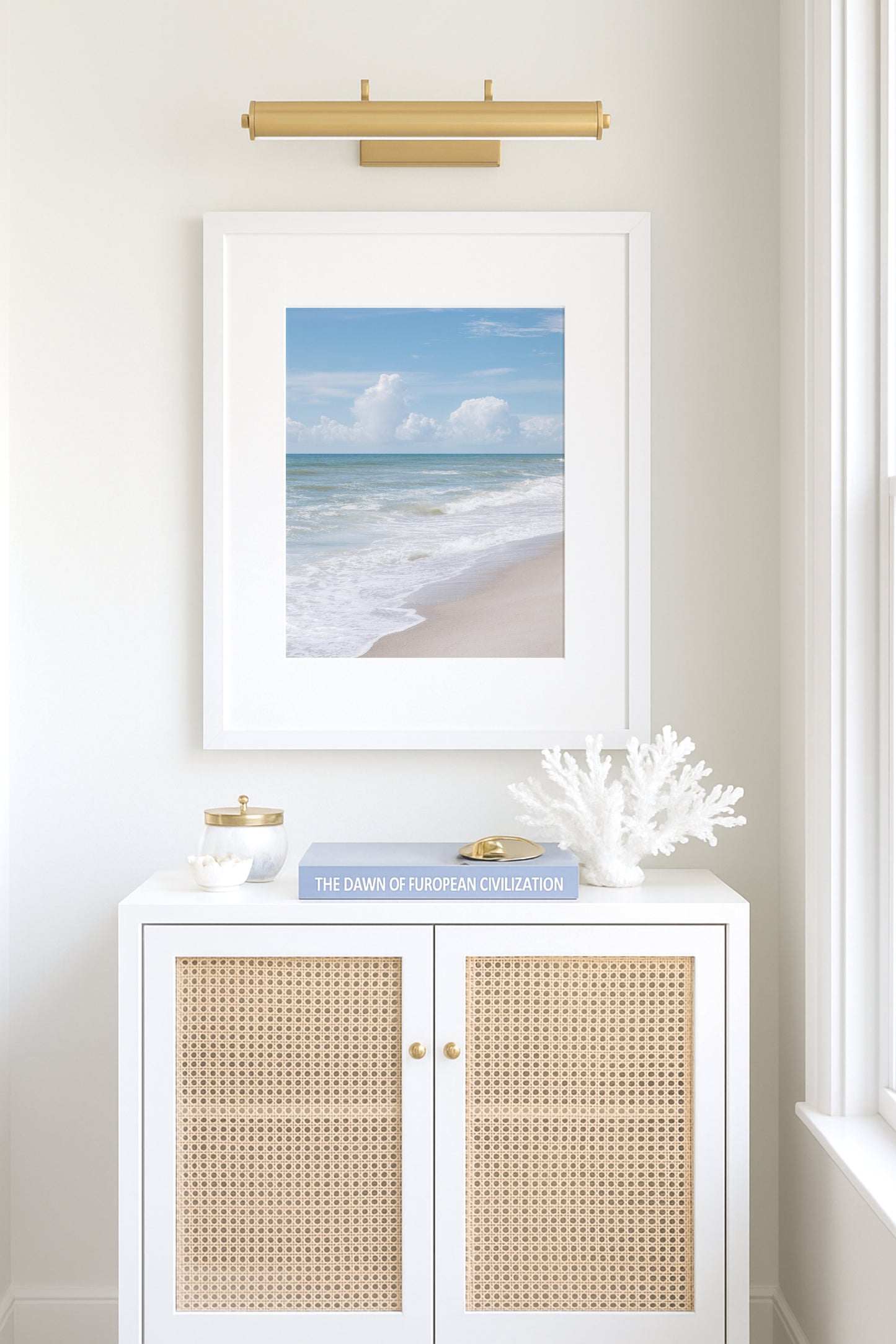 Vertical framed print featuring soft ocean waves and blue sky, photographed at Kure Beach, North Carolina. Ideal for coastal wall decor and minimalist beach interiors.