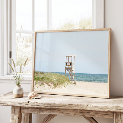 Color fine art photograph of an empty lifeguard stand at Bank Street Beach on Cape Cod — rolling sand dunes, sea grass, and the open Atlantic under a pale summer sky