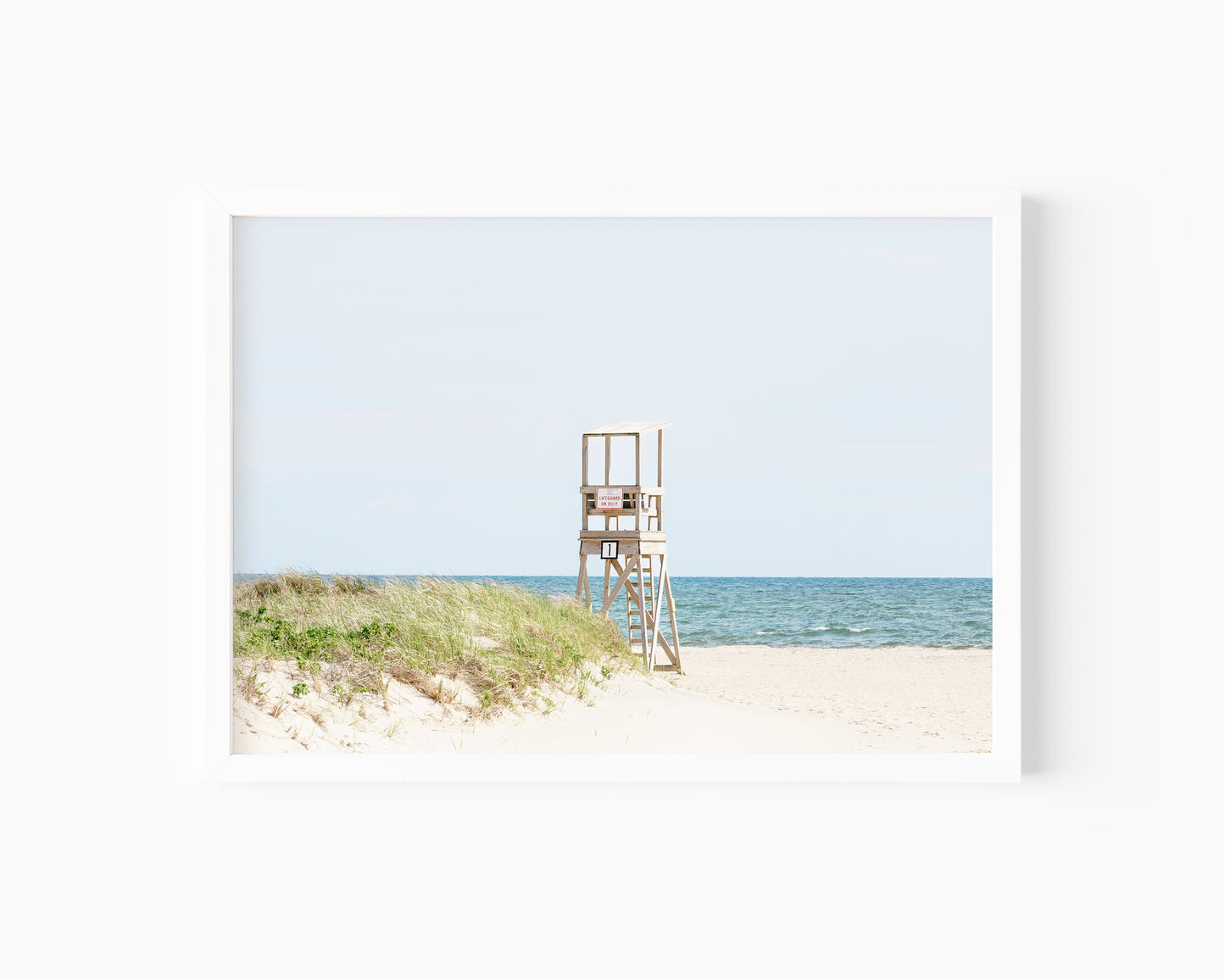 Color fine art photograph of an empty lifeguard stand at Bank Street Beach on Cape Cod — rolling sand dunes, sea grass, and the open Atlantic under a pale summer sky