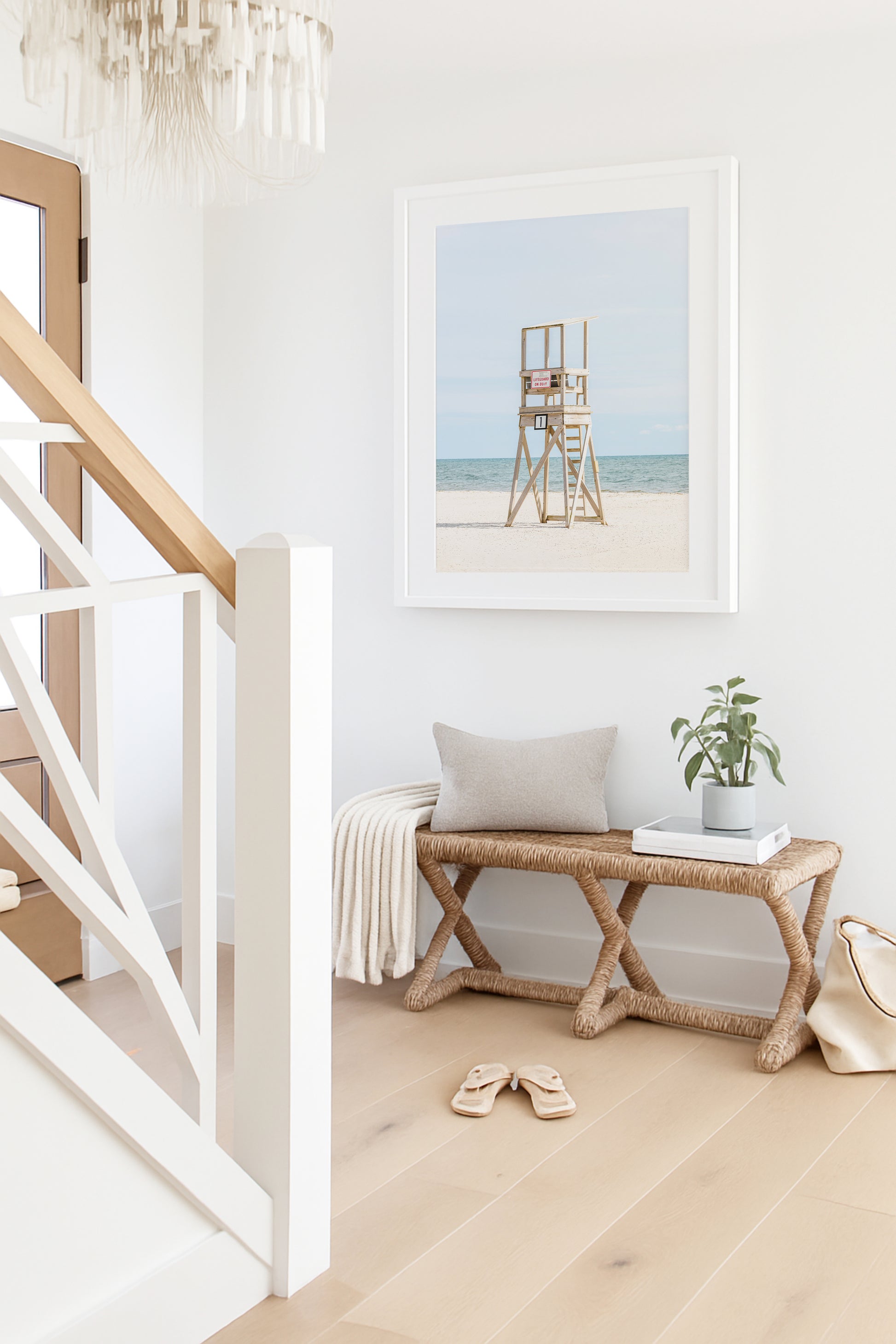 Color fine art photograph of an empty wooden lifeguard tower at Bank Street Beach in Harwich, Cape Cod — white sand and blue-green Atlantic in the background