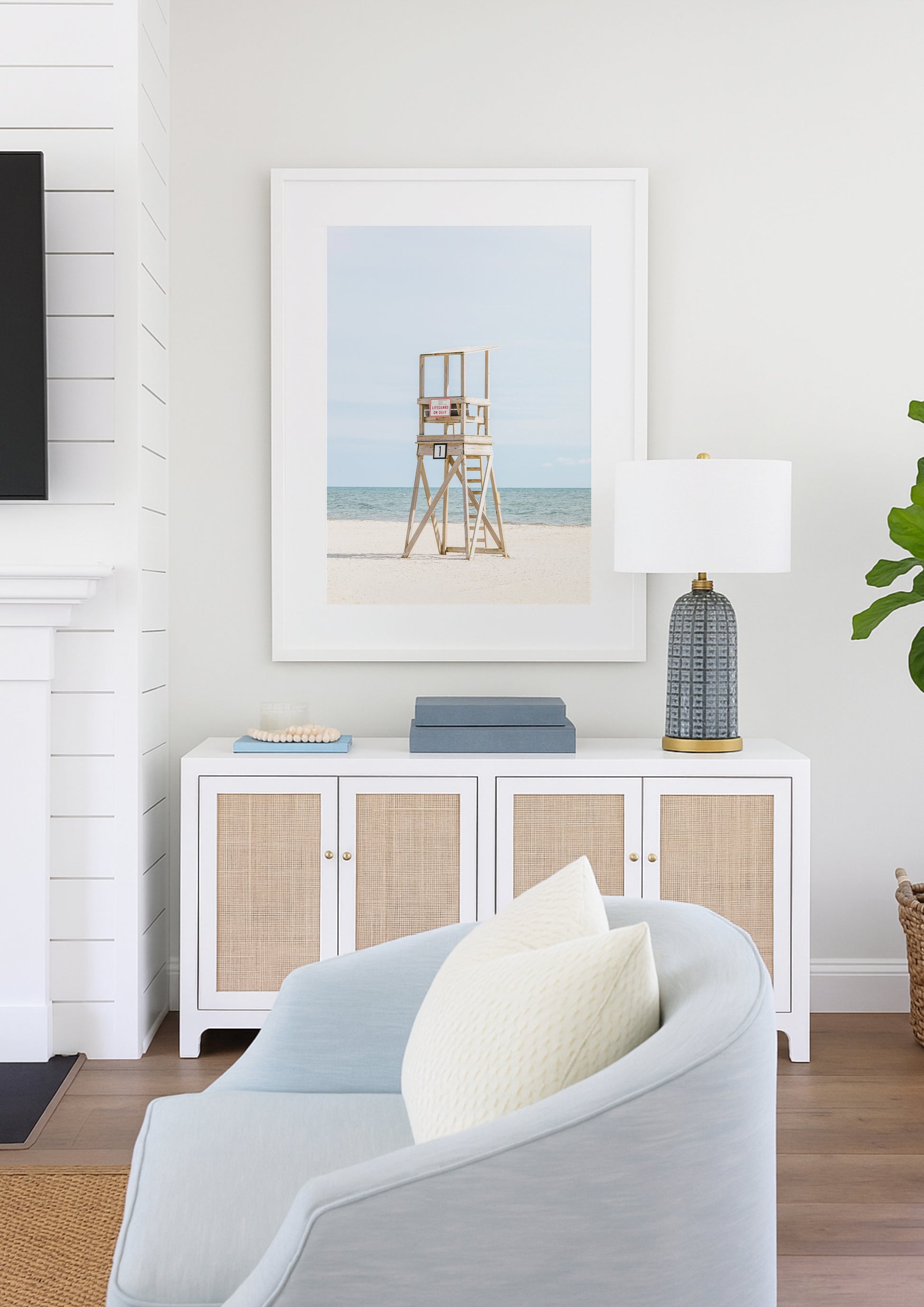 Color fine art photograph of an empty wooden lifeguard tower at Bank Street Beach in Harwich, Cape Cod — white sand and blue-green Atlantic in the background