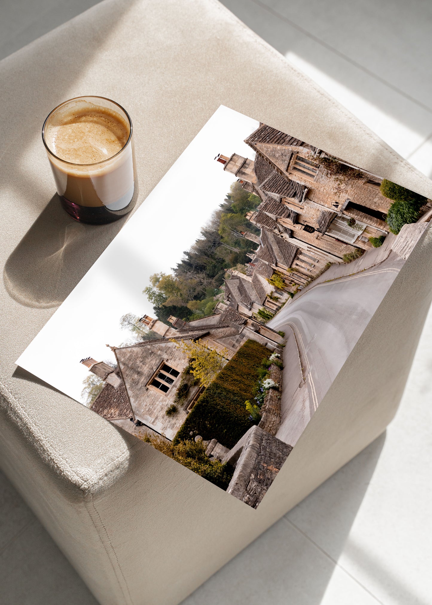 Photography print of Castle Combe village in the Cotswolds England featuring historic stone cottages and winding road