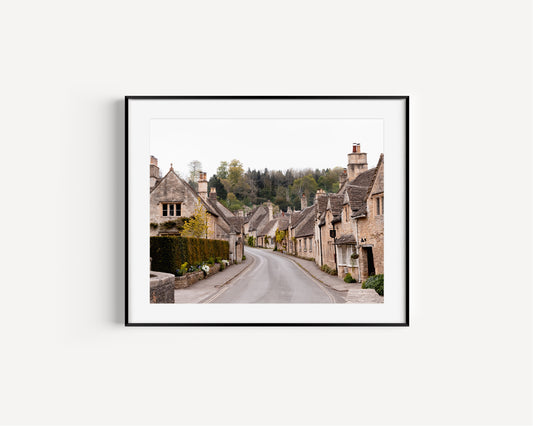 Photography print of Castle Combe village in the Cotswolds England featuring historic stone cottages and winding road