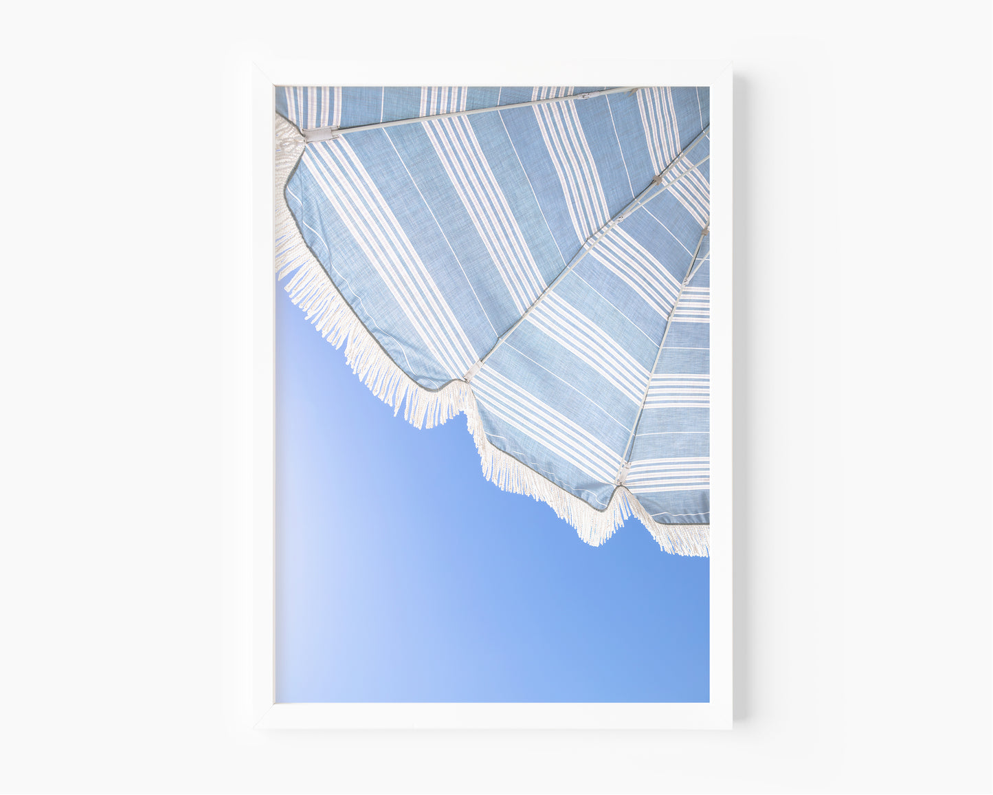 Blue and white beach umbrella print photographed in Santa Barbara Cali against clear blue sky
