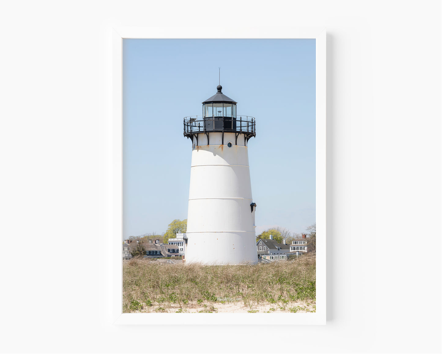 Edgartown Lighthouse photography print on Marthas Vineyard featuring a white lighthouse, dune grass, and soft blue sky in a coastal New England setting.