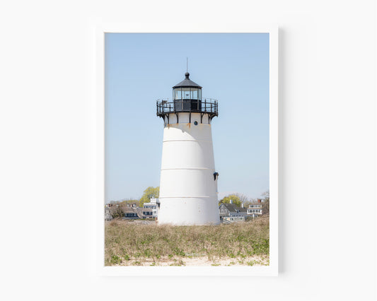 Edgartown Lighthouse photography print on Marthas Vineyard featuring a white lighthouse, dune grass, and soft blue sky in a coastal New England setting.