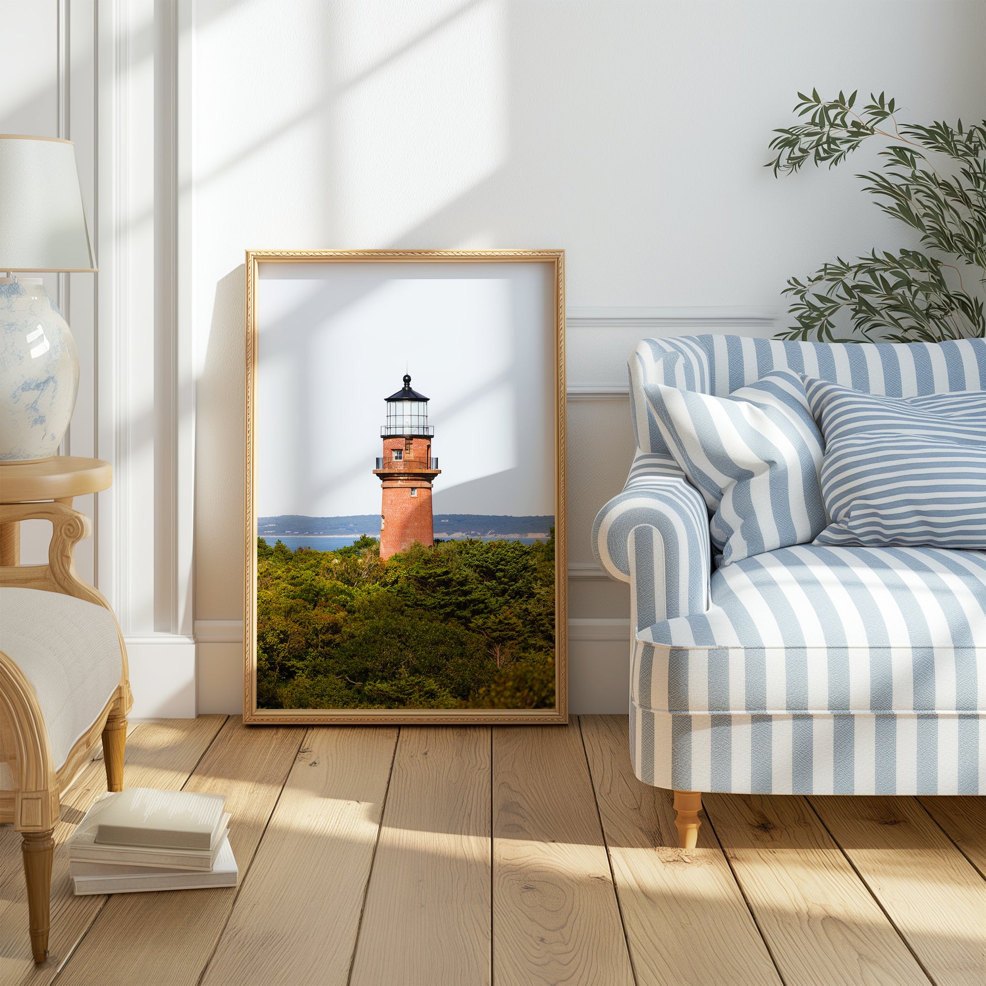 Lighthouse photo showing the red brick Gay Head Lighthouse above lush greenery in Aquinnah, Mass, with the Martha’s Vineyard coastline in the background.