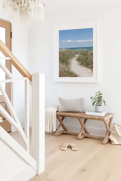 Color fine art photograph of a sandy beach path through dune grass on Martha’s Vineyard, blue-green ocean visible on the horizon under a clear blue summer sky with white clouds