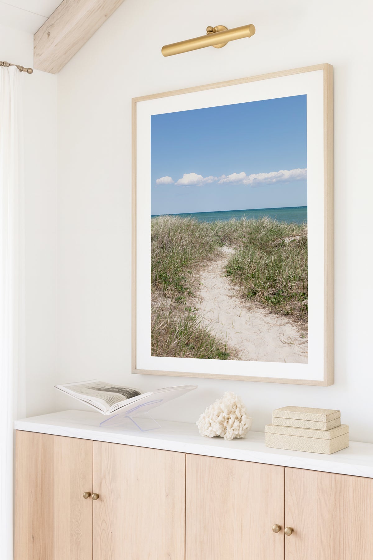 Color fine art photograph of a sandy beach path through dune grass on Martha’s Vineyard, blue-green ocean visible on the horizon under a clear blue summer sky with white clouds