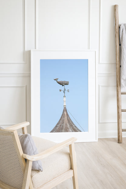 Whale weathervane Martha’s Vineyard photography print, weathered nautical weathervane on copper rooftop against pale blue sky, New England coastal wall art for beach house, cottage, or living room