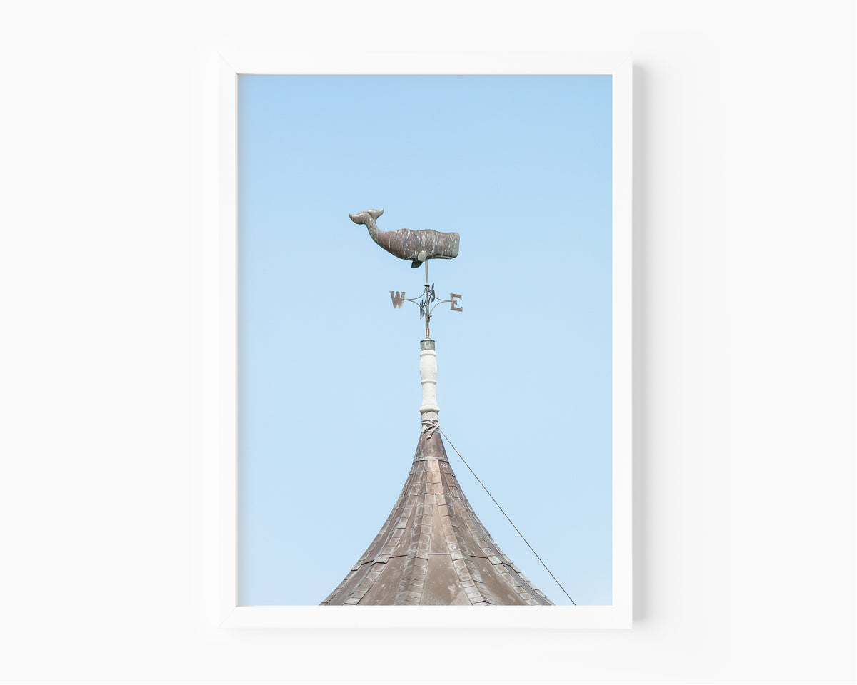 Whale weathervane Martha’s Vineyard photography print, weathered nautical weathervane on copper rooftop against pale blue sky, New England coastal wall art for beach house, cottage, or living room
