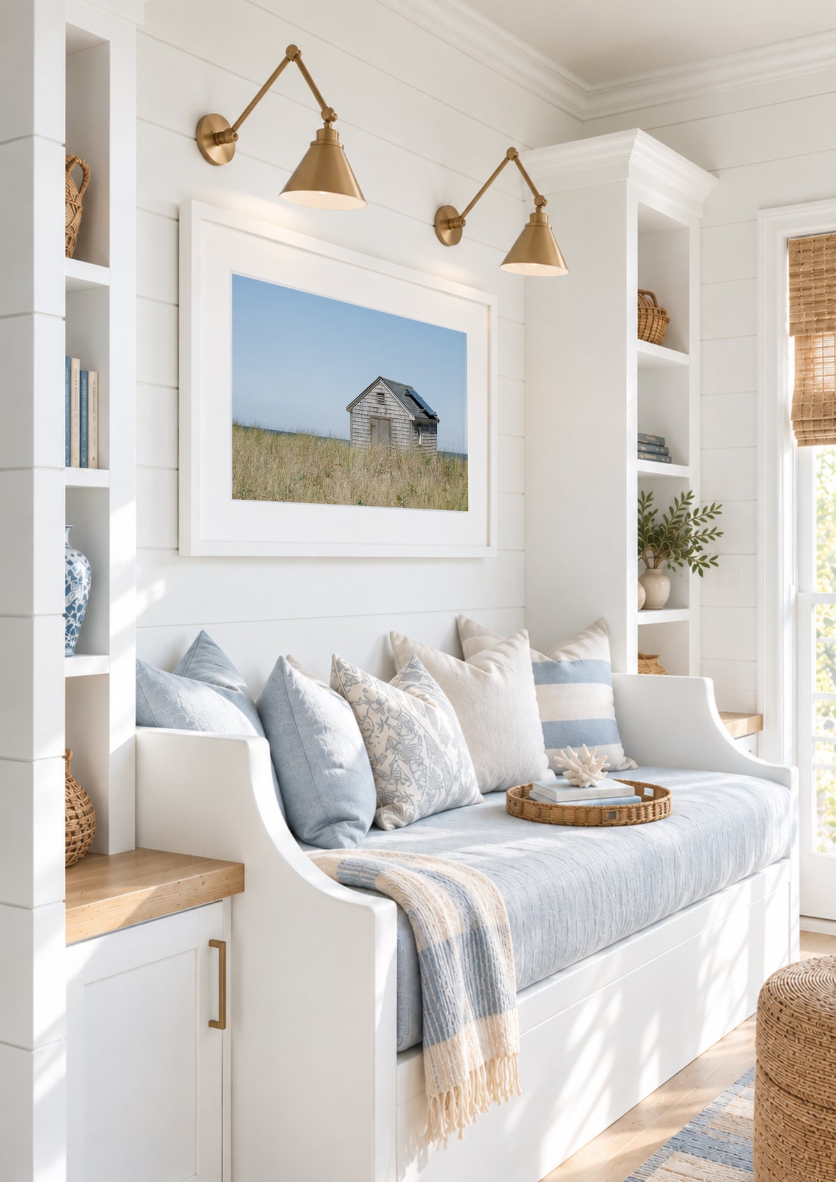 Color fine art photograph of a weathered grey shingle beach cottage alone in golden dune grass on Nantucket Island — ocean visible on the horizon under a wide pale blue sky